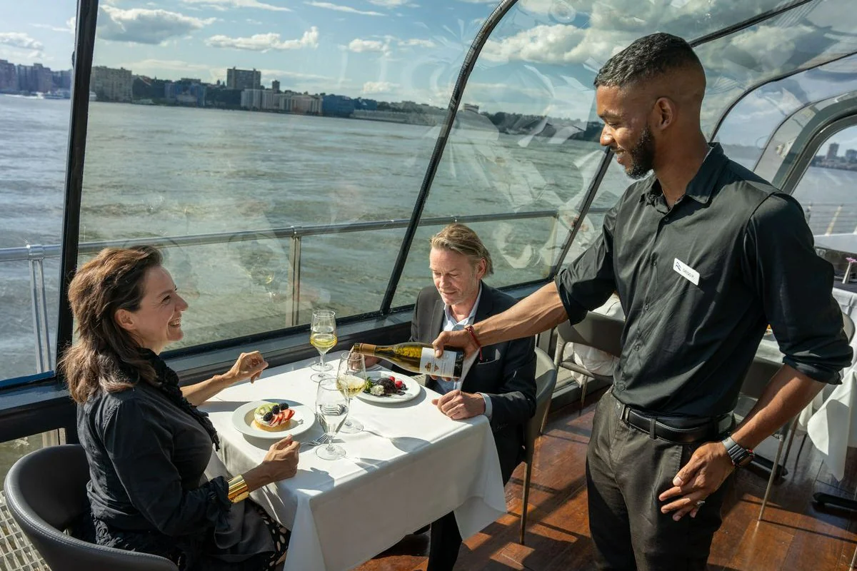 Waiter serving drinks on NYC dinner cruise